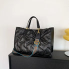 Stay on-trend with this fashion-forward large tote padded handbag featuring a designer quilted design. This stylish accessory is perfect for adding a touch of sophistication and elegance to your ensemble. -