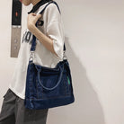 Elevate your casual look with this denim shoulder bag for women. Featuring a large design and zipper closure, this bag is perfect for shopping and everyday use, adding a touch of style to your outfit. -