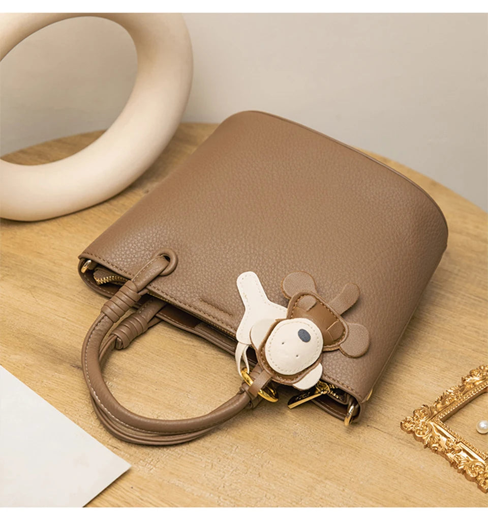 Upgrade your accessories with this new bucket bag for women. Featuring a fashionable and versatile design, this handheld bag is perfect for adding a chic and trendy touch to your look. -