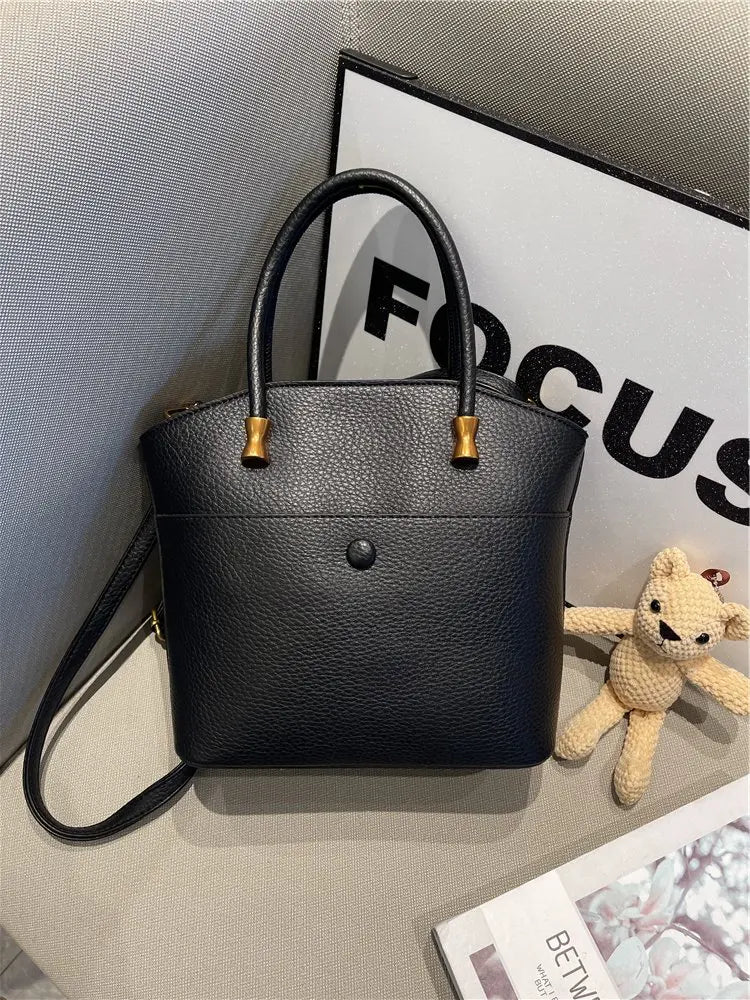 Elevate your style with this elegant tote bag. Crafted from genuine leather, this bag exudes sophistication and is the perfect accessory for a chic and classy look. -