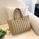 Carry your essentials in style with this large capacity and cotton-padded tote bag designed for ladies. Featuring a solid color and casual fashion, this bag is both practical and fashionable for everyday use. -