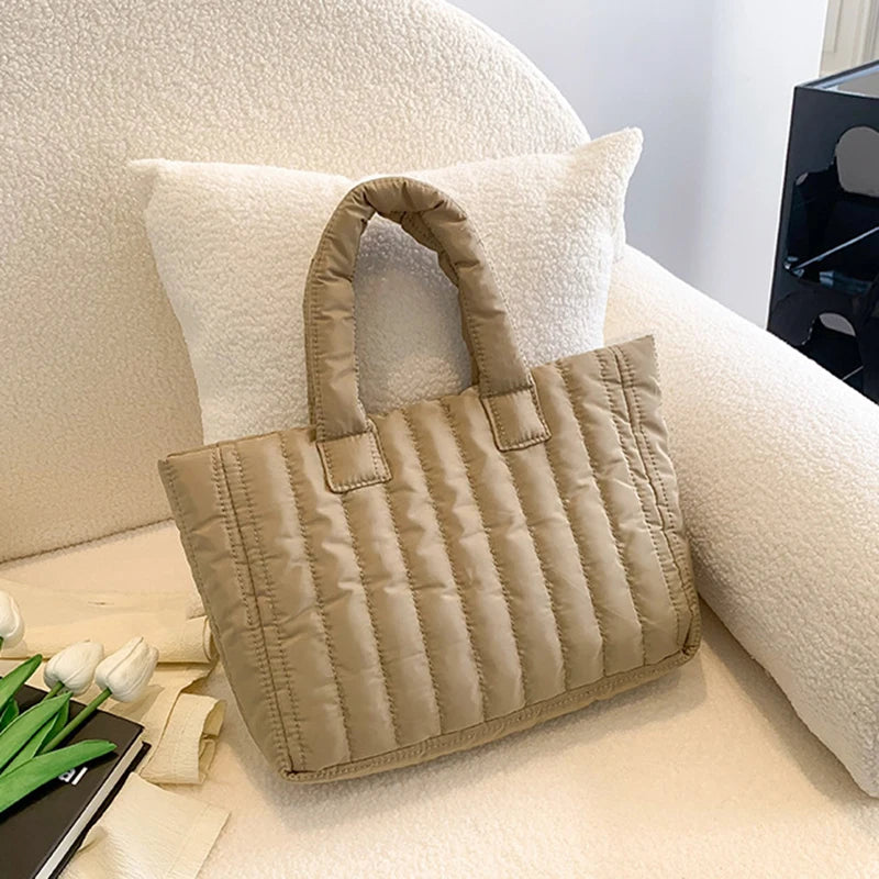 Carry your essentials in style with this large capacity and cotton-padded tote bag designed for ladies. Featuring a solid color and casual fashion, this bag is both practical and fashionable for everyday use. -