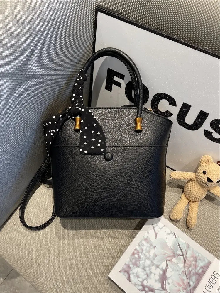Elevate your style with this elegant tote bag. Crafted from genuine leather, this bag exudes sophistication and is the perfect accessory for a chic and classy look. -