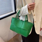 Make a fashion statement with this large capacity handbag. Crafted with stylish woven leather, this tote bag is perfect for adding a touch of elegance to your everyday outfit. -