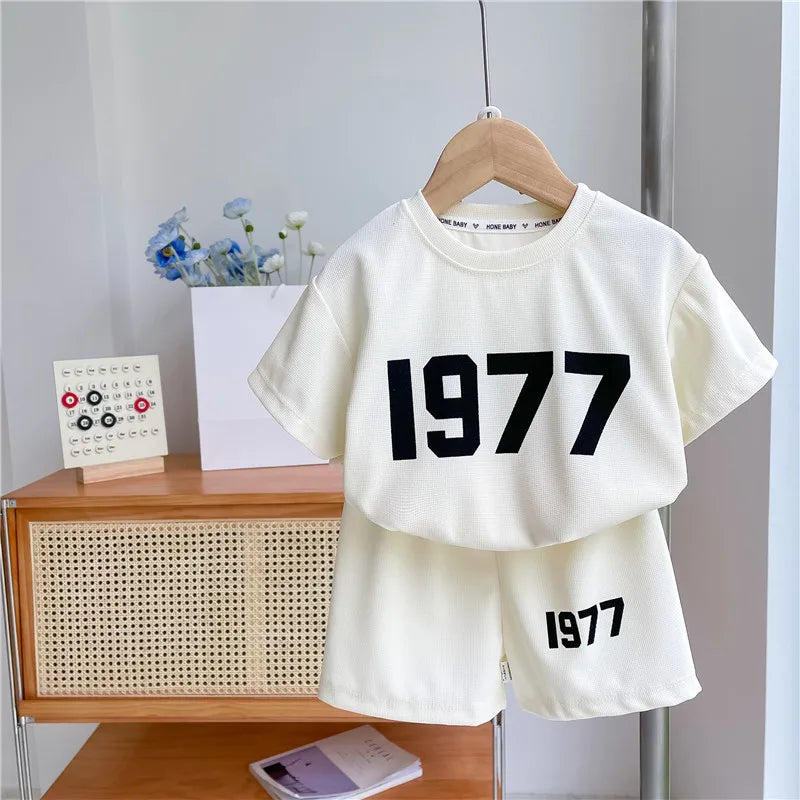 Dress your little athletes in style with this trendy two-piece set—featuring printed short-sleeve tops and shorts for both boys and girls! -