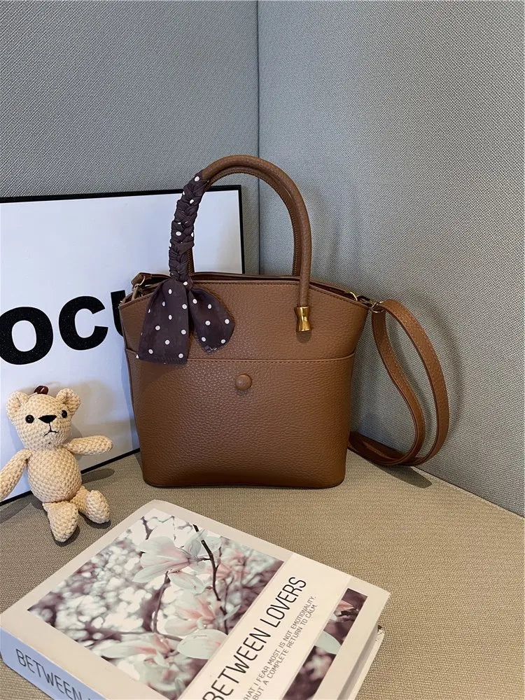 Elevate your style with this elegant tote bag. Crafted from genuine leather, this bag exudes sophistication and is the perfect accessory for a chic and classy look. -