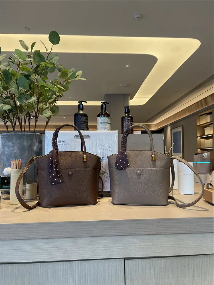 Elevate your style with this elegant tote bag. Crafted from genuine leather, this bag exudes sophistication and is the perfect accessory for a chic and classy look. -