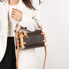 Make a statement with this luxurious and elegant box bag for women. Crafted from high-quality leather, this shoulder handbag features an elegant top-handle design, exuding sophistication and style for a classy finishing touch to your ensemble. -