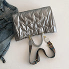 Stay on-trend with this fashion-forward large tote padded handbag featuring a designer quilted design. This stylish accessory is perfect for adding a touch of sophistication and elegance to your ensemble. -