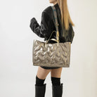Stay on-trend with this fashion-forward large tote padded handbag featuring a designer quilted design. This stylish accessory is perfect for adding a touch of sophistication and elegance to your ensemble. -