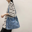 Elevate your casual look with this denim shoulder bag for women. Featuring a large design and zipper closure, this bag is perfect for shopping and everyday use, adding a touch of style to your outfit. -