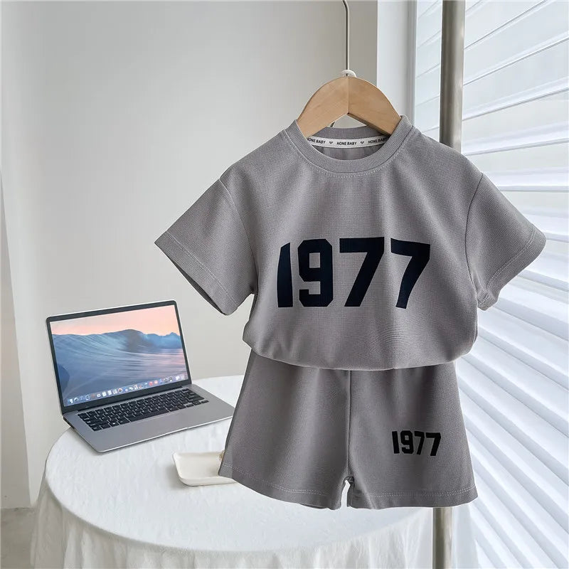 Dress your little athletes in style with this trendy two-piece set—featuring printed short-sleeve tops and shorts for both boys and girls! -