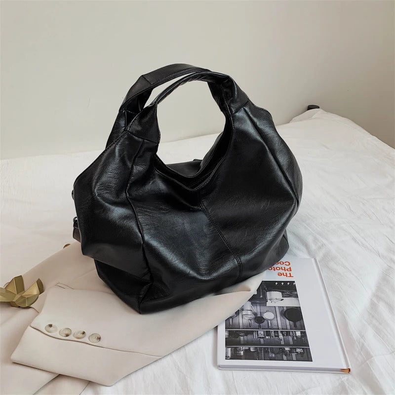 Make a stylish statement with these large shoulder bags designed for women. Crafted from soft leather, these fashionable handbags are perfect for adding a touch of sophistication to any outfit. -