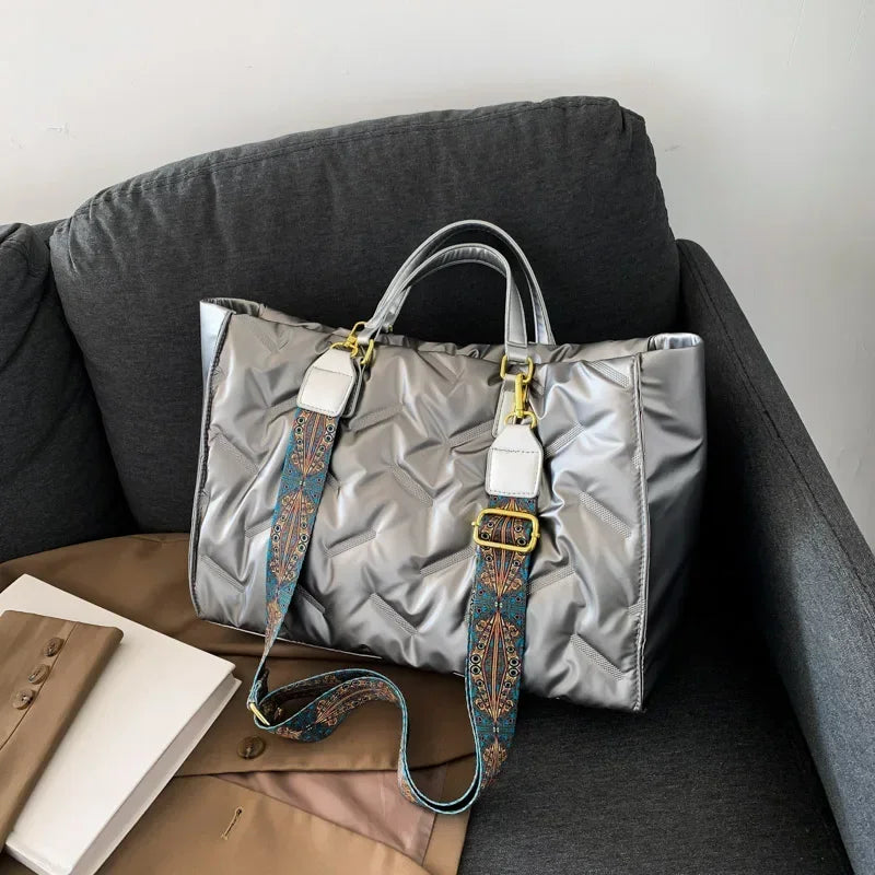 Stay on-trend with this fashion-forward large tote padded handbag featuring a designer quilted design. This stylish accessory is perfect for adding a touch of sophistication and elegance to your ensemble. -