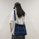 Elevate your casual look with this denim shoulder bag for women. Featuring a large design and zipper closure, this bag is perfect for shopping and everyday use, adding a touch of style to your outfit. -