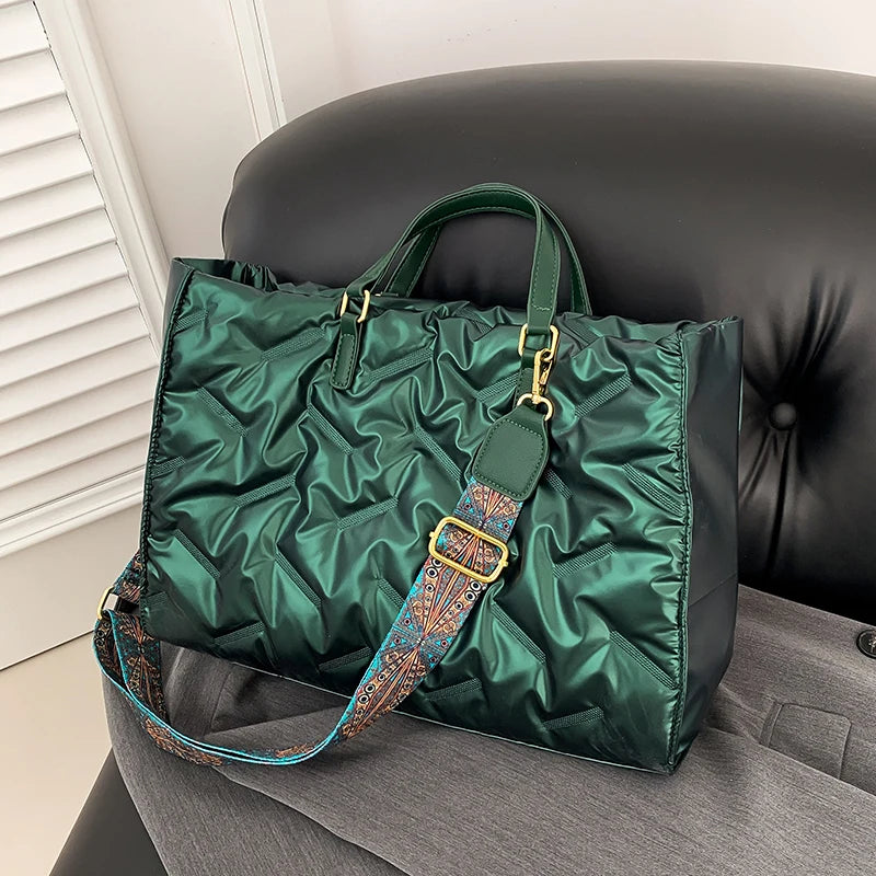 Stay on-trend with this fashion-forward large tote padded handbag featuring a designer quilted design. This stylish accessory is perfect for adding a touch of sophistication and elegance to your ensemble. -
