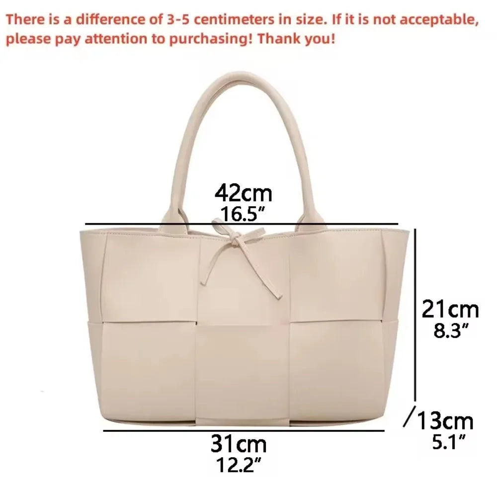 Make a fashion statement with this large capacity handbag. Crafted with stylish woven leather, this tote bag is perfect for adding a touch of elegance to your everyday outfit. -