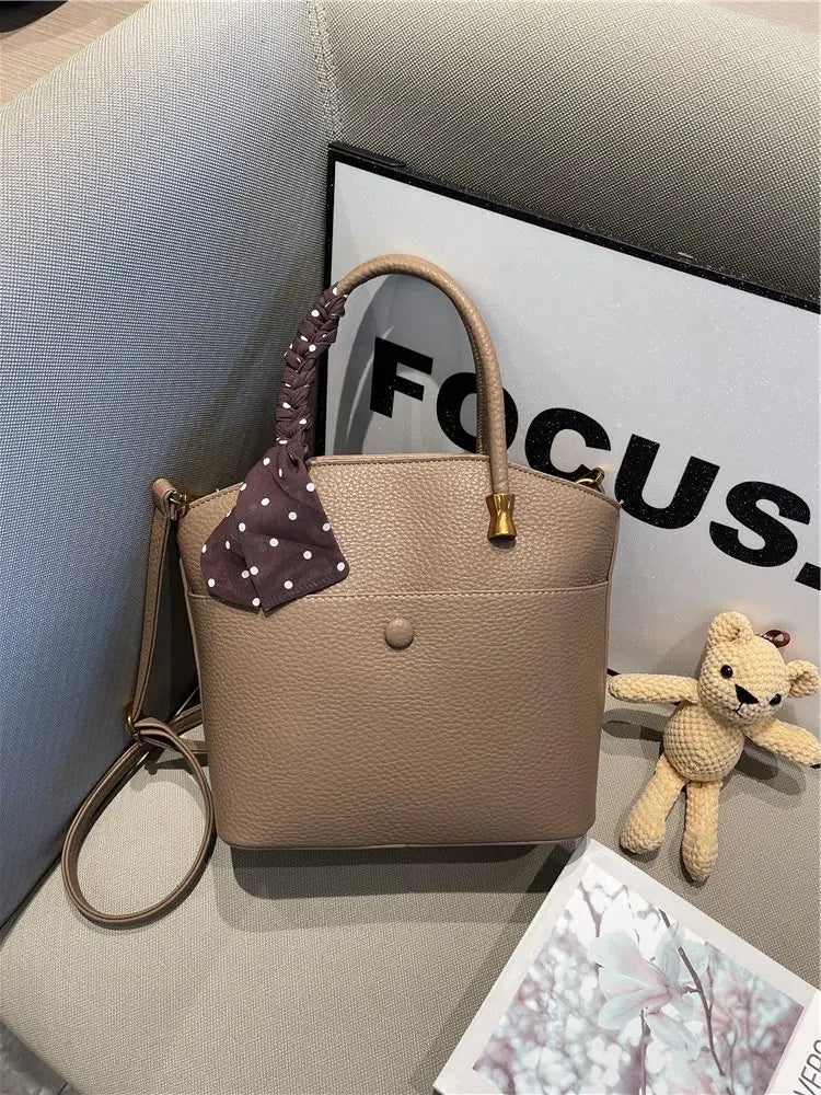 Elevate your style with this elegant tote bag. Crafted from genuine leather, this bag exudes sophistication and is the perfect accessory for a chic and classy look. -