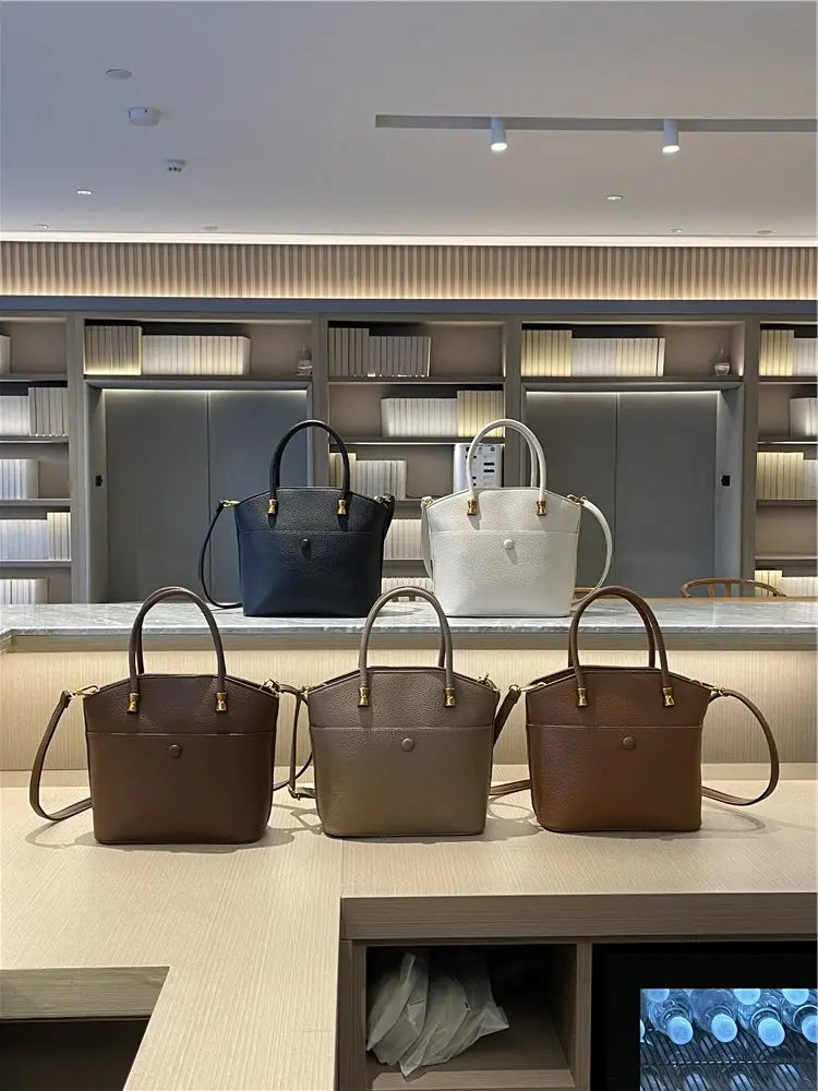 Elevate your style with this elegant tote bag. Crafted from genuine leather, this bag exudes sophistication and is the perfect accessory for a chic and classy look. -