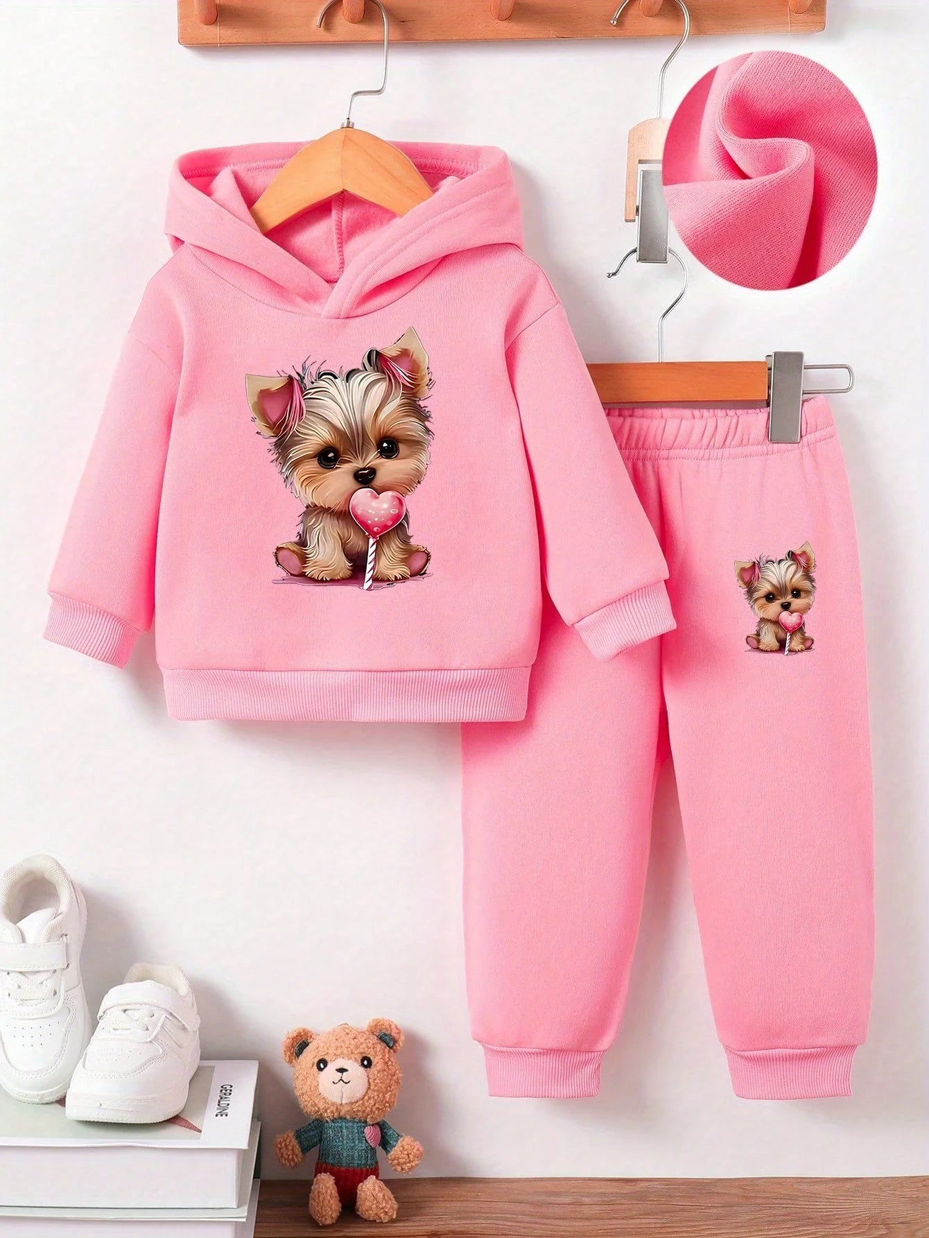 Keep your baby girl cozy and adorable with this fleece hoodie and pants set featuring a cute dog pattern print! -