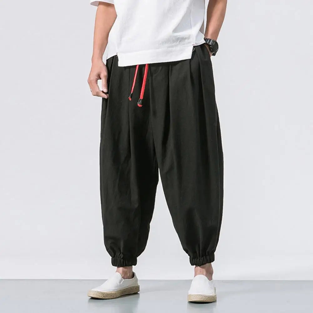 Stay comfortable and stylish in these men's baggy jogging pants featuring a drawstring waist—an ideal choice for a relaxed and casual look! -