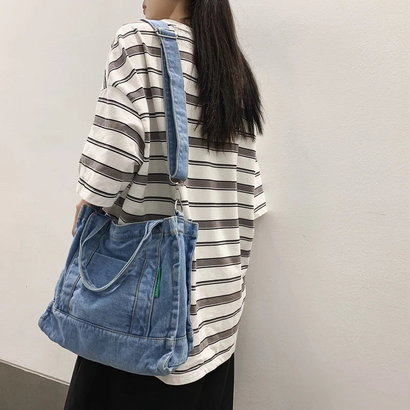 Elevate your casual look with this denim shoulder bag for women. Featuring a large design and zipper closure, this bag is perfect for shopping and everyday use, adding a touch of style to your outfit. -