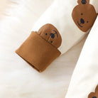Keep your newborn baby boy cozy and adorable this spring with this 2-piece set—featuring a long-sleeved bear print romper and matching hat, perfect for ages 0-1 year! -