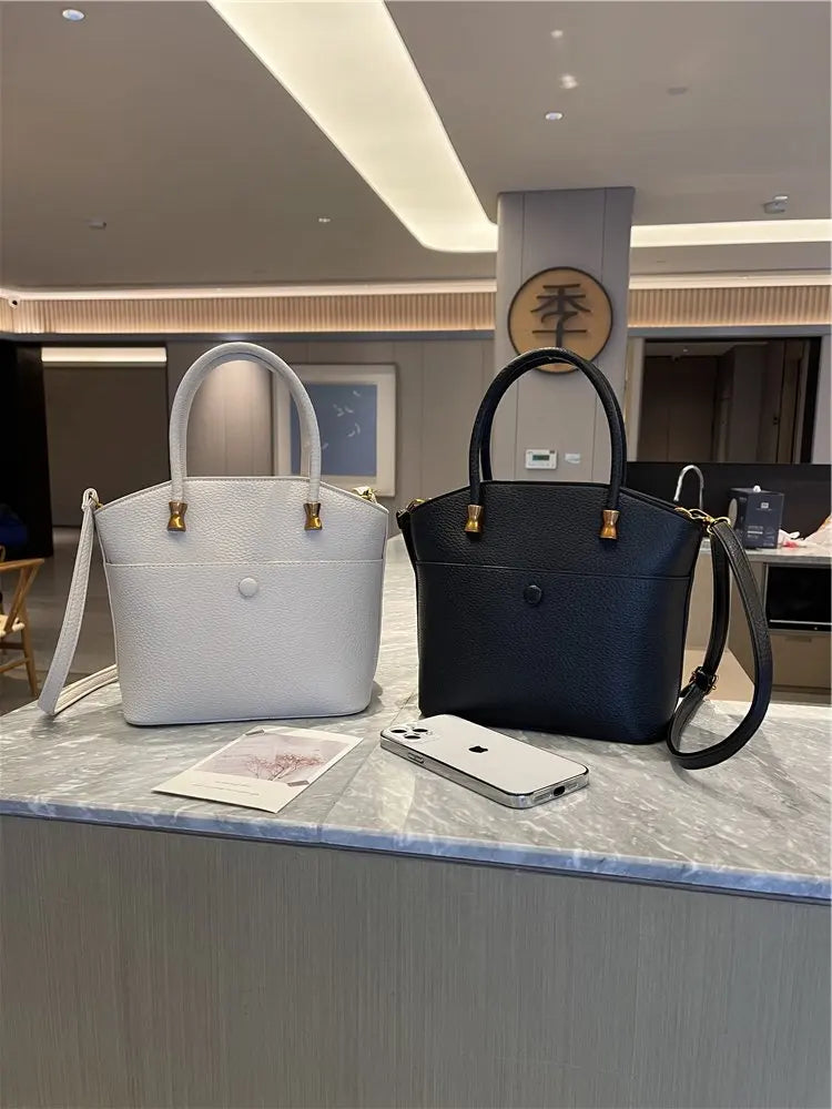 Elevate your style with this elegant tote bag. Crafted from genuine leather, this bag exudes sophistication and is the perfect accessory for a chic and classy look. -