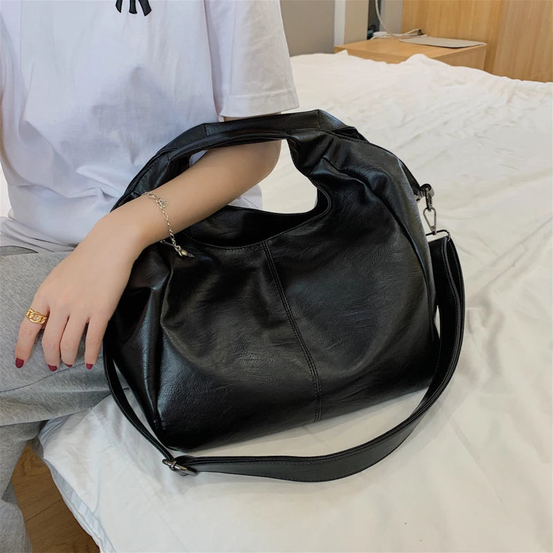 Make a stylish statement with these large shoulder bags designed for women. Crafted from soft leather, these fashionable handbags are perfect for adding a touch of sophistication to any outfit. -