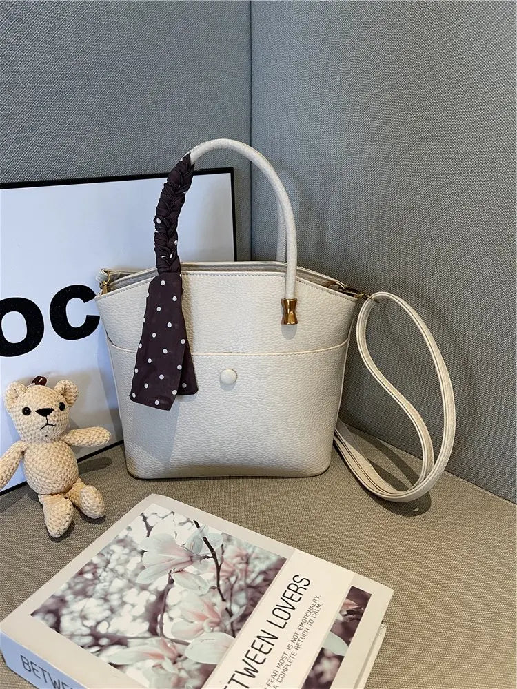 Elevate your style with this elegant tote bag. Crafted from genuine leather, this bag exudes sophistication and is the perfect accessory for a chic and classy look. -