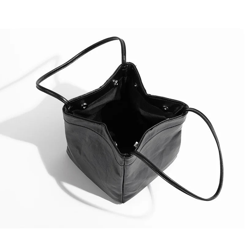 Stay on-trend with this bucket bag—a new fashion staple that offers simplicity, versatility, and a touch of classic style to elevate your wardrobe! -