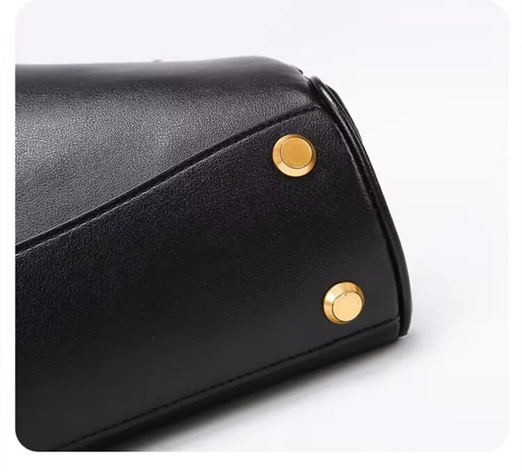 Elevate your style with this genuine leather women's tote bag. Featuring a distinctive gold buckle, this elegant handbag is perfect for commuting and adding a touch of sophistication to your look. -
