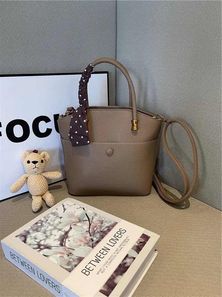 Elevate your style with this elegant tote bag. Crafted from genuine leather, this bag exudes sophistication and is the perfect accessory for a chic and classy look. -