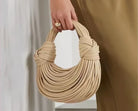 Make a statement with this gold luxury designer brand handwoven noodle bag. With a rope-knotted hobo design and a chic silver evening clutch, this bag is the epitome of high fashion and sophistication. -
