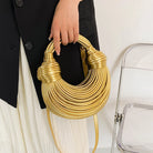 Make a statement with this gold luxury designer brand handwoven noodle bag. With a rope-knotted hobo design and a chic silver evening clutch, this bag is the epitome of high fashion and sophistication. -