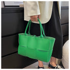 Make a fashion statement with this large capacity handbag. Crafted with stylish woven leather, this tote bag is perfect for adding a touch of elegance to your everyday outfit. -