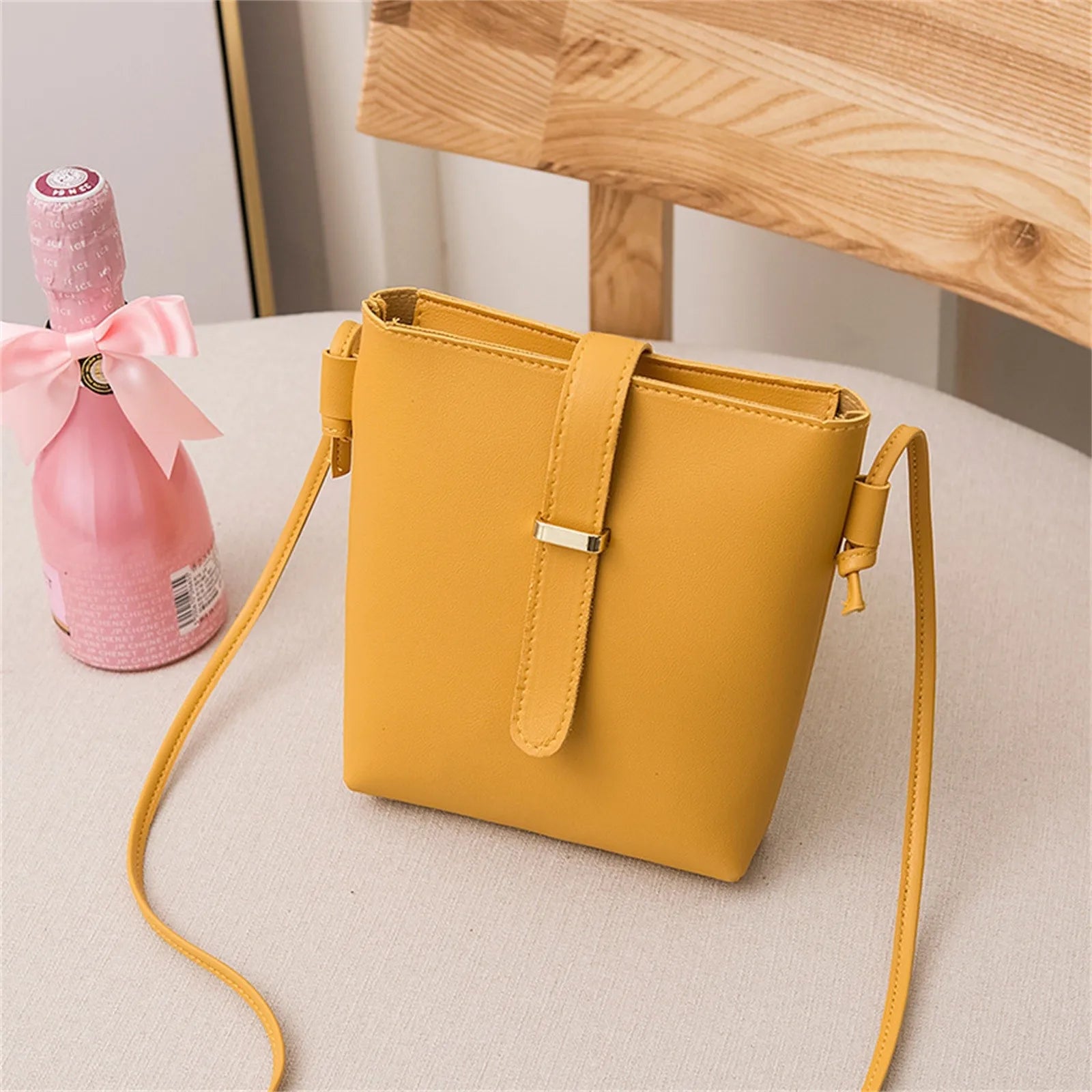 Stay on trend with this fashionable drawstring lady bag, featuring a stylish cross-border design and casual letter detail. Perfect for adding a chic and trendy touch to your outfit! -