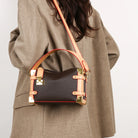 Make a statement with this luxurious and elegant box bag for women. Crafted from high-quality leather, this shoulder handbag features an elegant top-handle design, exuding sophistication and style for a classy finishing touch to your ensemble. -