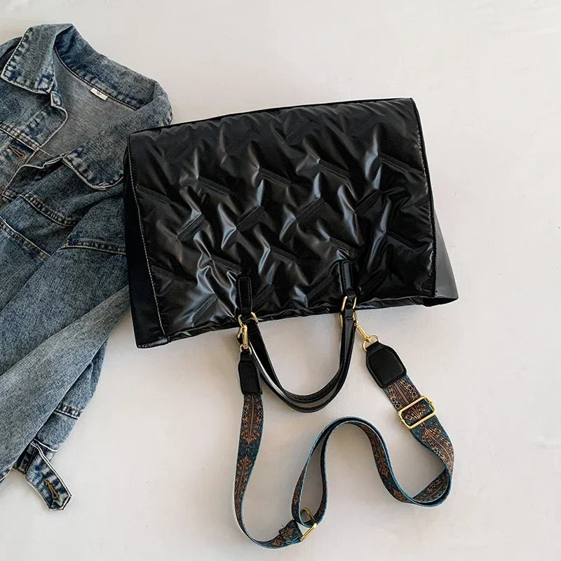 Stay on-trend with this fashion-forward large tote padded handbag featuring a designer quilted design. This stylish accessory is perfect for adding a touch of sophistication and elegance to your ensemble. -