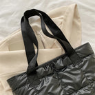 Stay stylish and organized with this fashion women's tote bag. Featuring a large capacity and cotton-padded design, this chic accessory is perfect for women who prioritize both style and functionality in their handbag. -