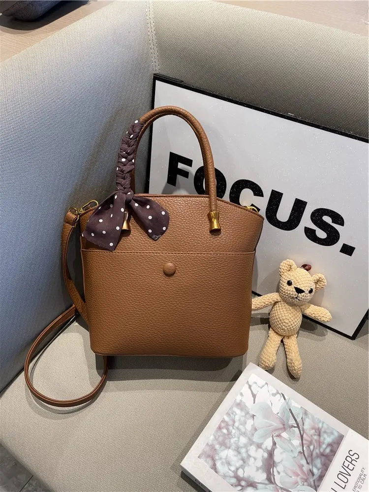 Elevate your style with this elegant tote bag. Crafted from genuine leather, this bag exudes sophistication and is the perfect accessory for a chic and classy look. -