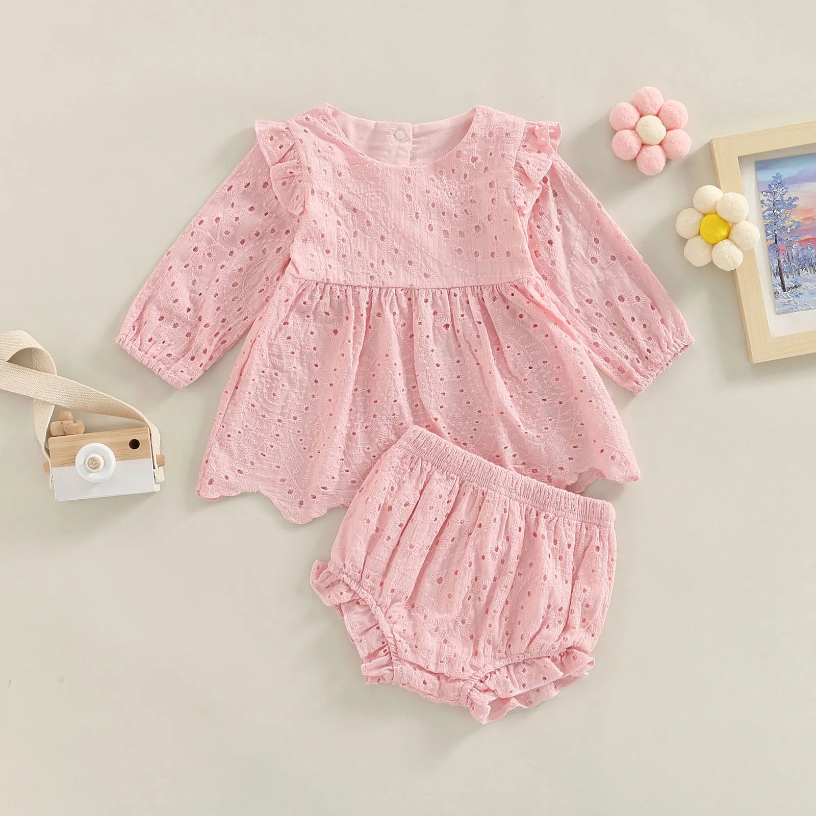 Keep your toddler cozy and cute in this 2-piece set featuring a solid color cutout round neck long sleeve top and matching bottoms—perfect for baby girls 3-24m! -