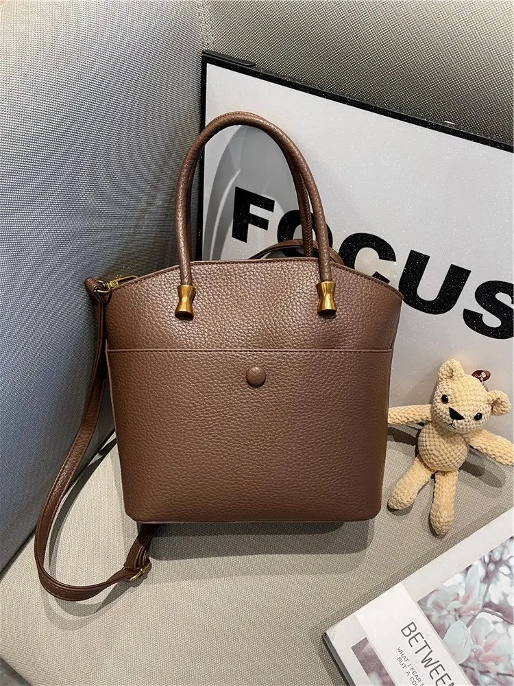 Elevate your style with this elegant tote bag. Crafted from genuine leather, this bag exudes sophistication and is the perfect accessory for a chic and classy look. -
