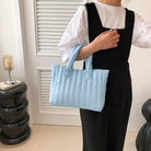 Carry your essentials in style with this large capacity and cotton-padded tote bag designed for ladies. Featuring a solid color and casual fashion, this bag is both practical and fashionable for everyday use. -