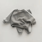 Keep your little one stylish and comfy with this cool two-piece baby suit—featuring a letter-printed zip-up top and matching leisure sports pants! -