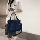 Elevate your casual look with this denim shoulder bag for women. Featuring a large design and zipper closure, this bag is perfect for shopping and everyday use, adding a touch of style to your outfit. -