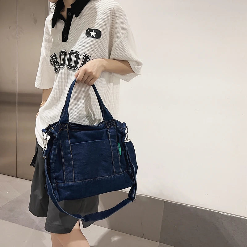 Elevate your casual look with this denim shoulder bag for women. Featuring a large design and zipper closure, this bag is perfect for shopping and everyday use, adding a touch of style to your outfit. -