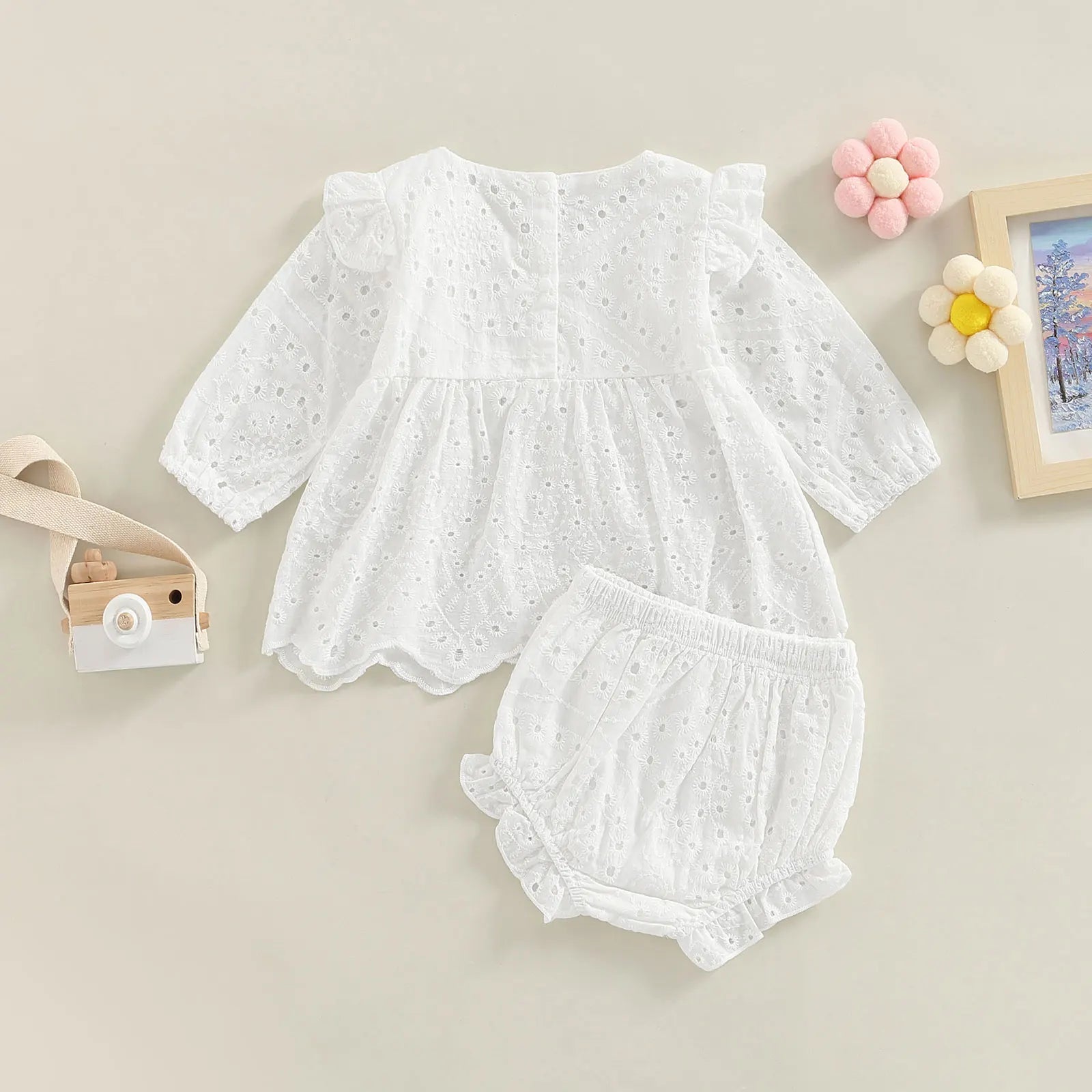 Keep your toddler cozy and cute in this 2-piece set featuring a solid color cutout round neck long sleeve top and matching bottoms—perfect for baby girls 3-24m! -