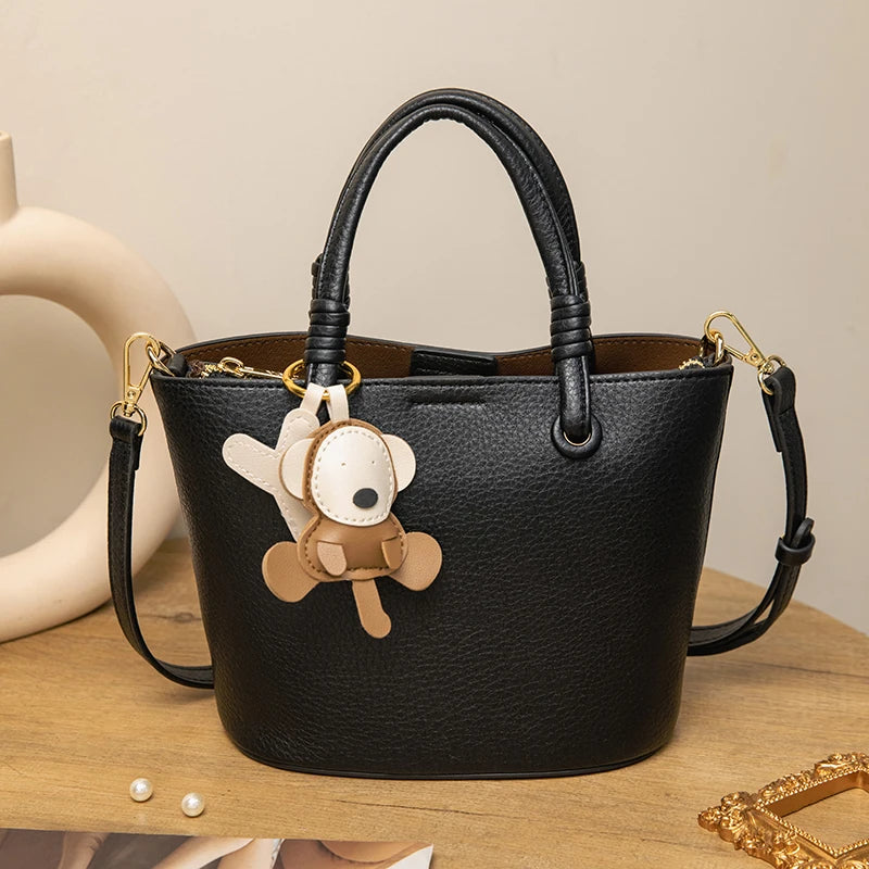 Upgrade your accessories with this new bucket bag for women. Featuring a fashionable and versatile design, this handheld bag is perfect for adding a chic and trendy touch to your look. -