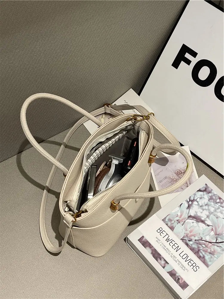 Elevate your style with this elegant tote bag. Crafted from genuine leather, this bag exudes sophistication and is the perfect accessory for a chic and classy look. -